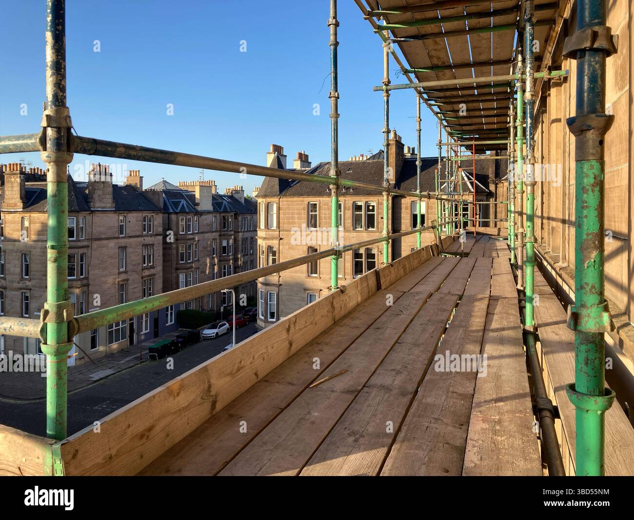Scaffolding Scaffold tower surrounding an Edinburgh tenement in preparation for roof repairs, Edinburgh Scotland, UK Stock Photo