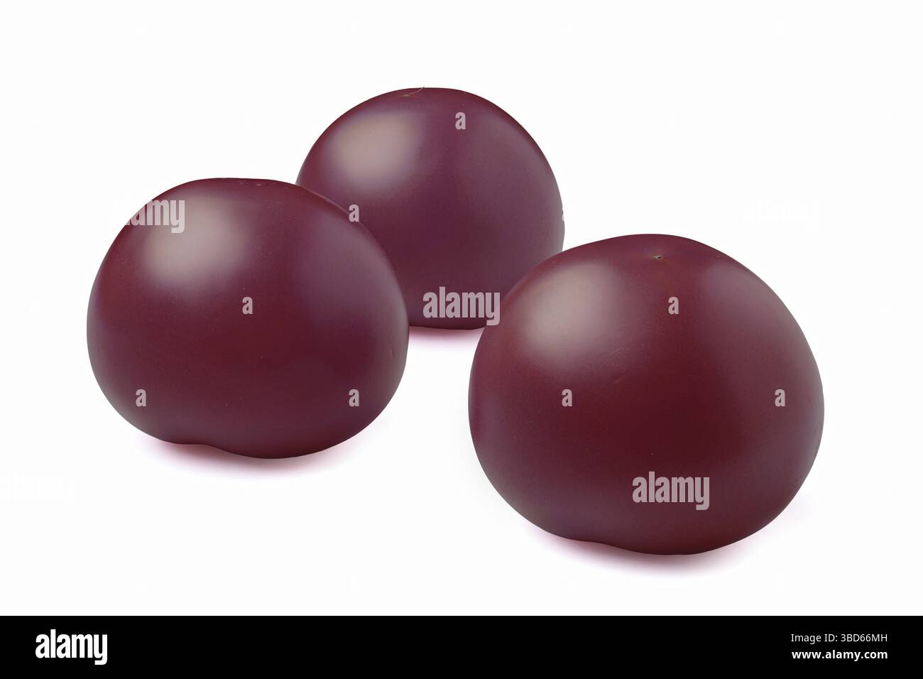 Three purple tomatoes isolated on white background Stock Photo