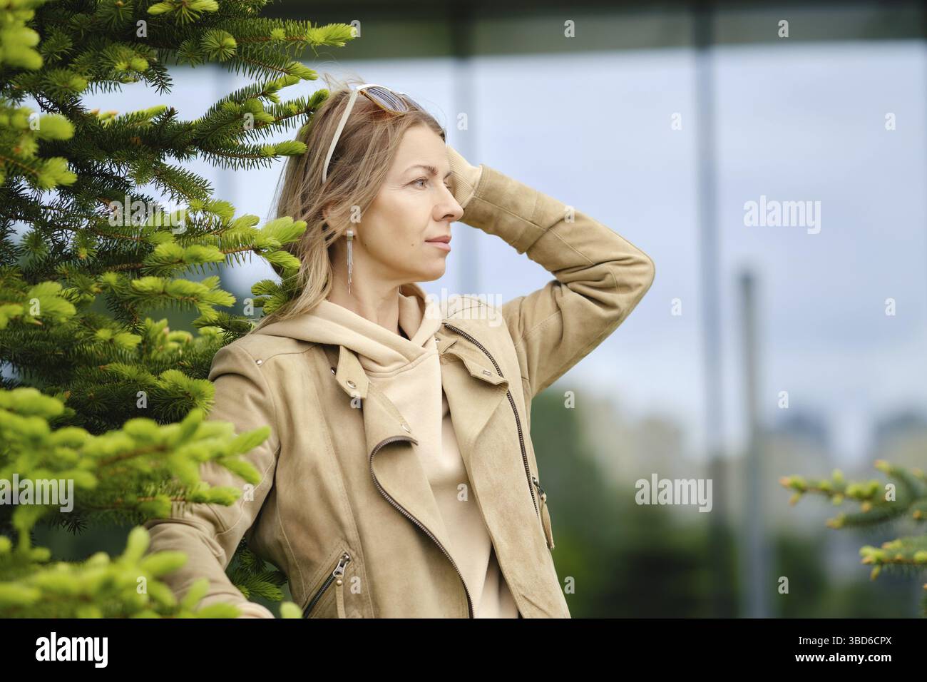 Pretty middle-aged woman looks into the distance Stock Photo