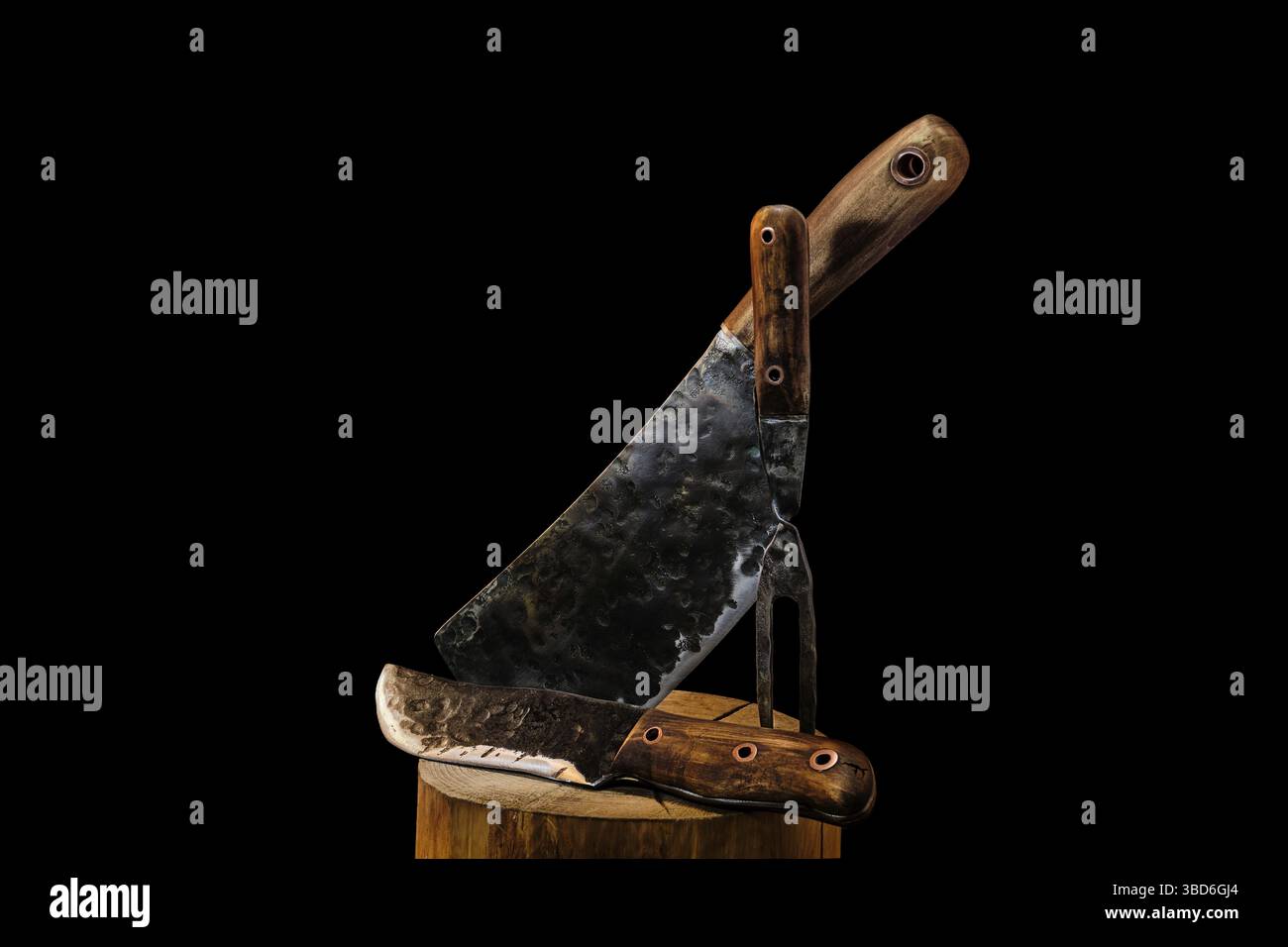 Rustic butcher meat knife, cleaver and fork on black background Stock Photo
