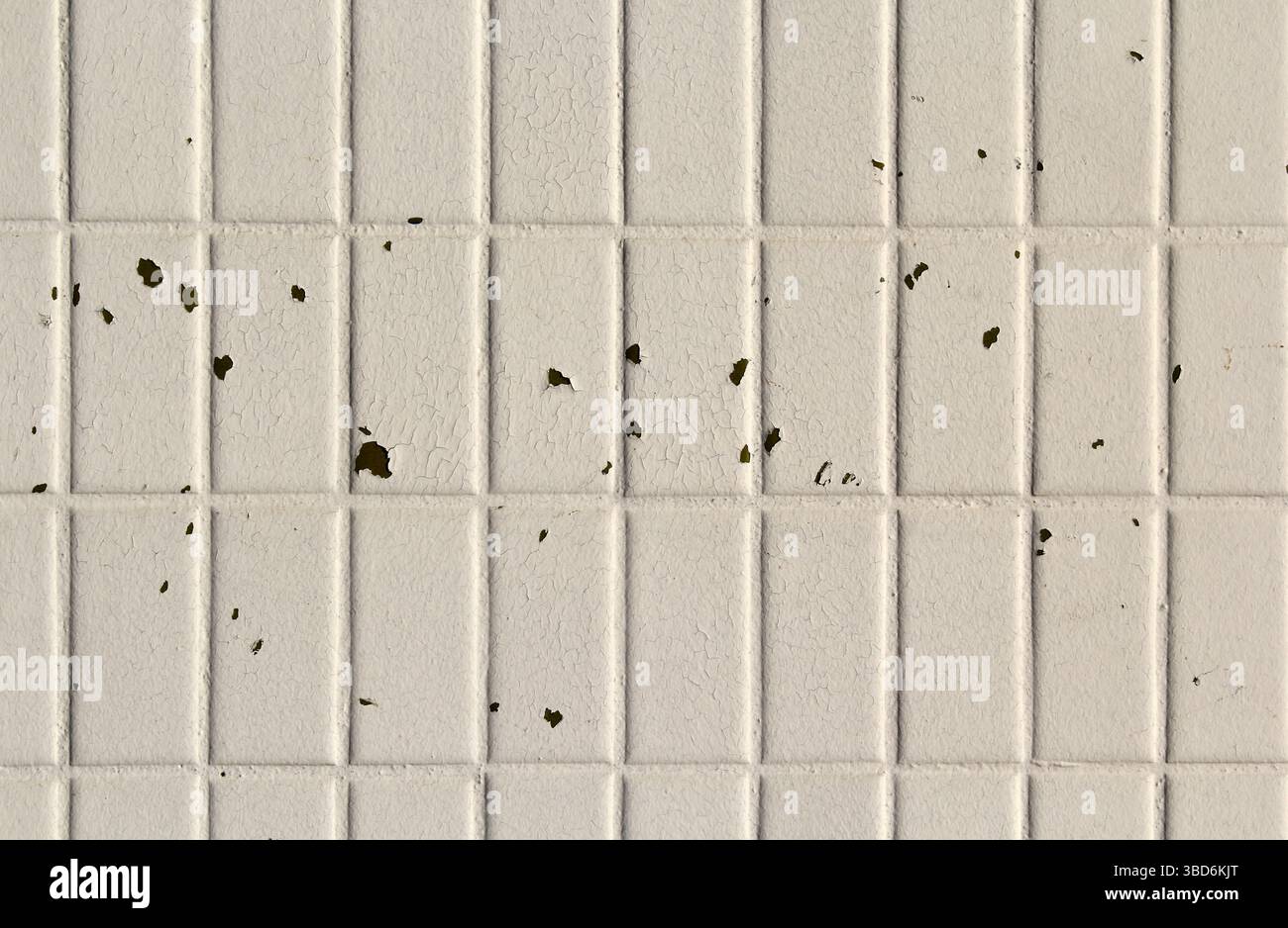 White tiled surface with peeling paint abstract textured background Stock Photo