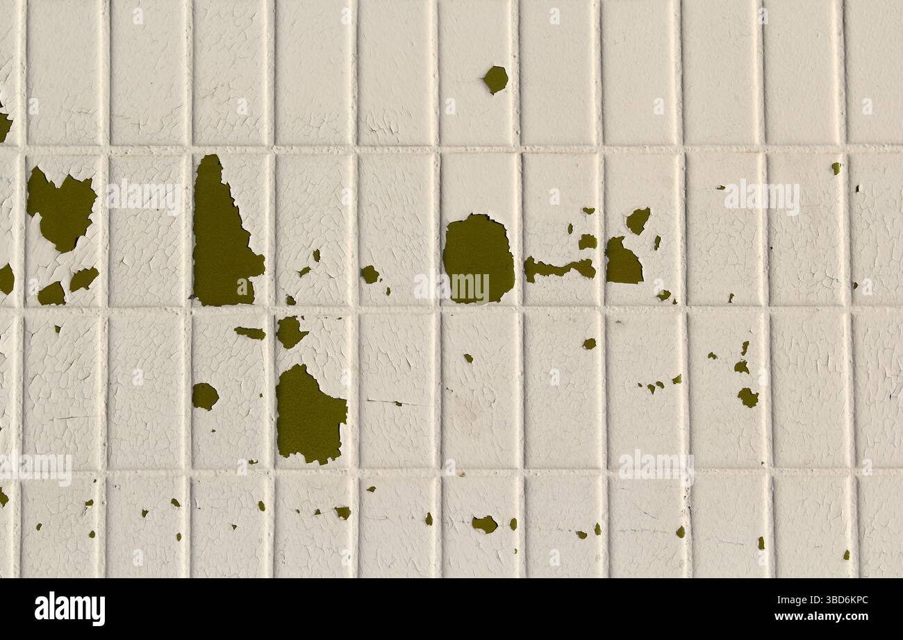 Peeling paint on damaged white tiles abstract textured background Stock Photo