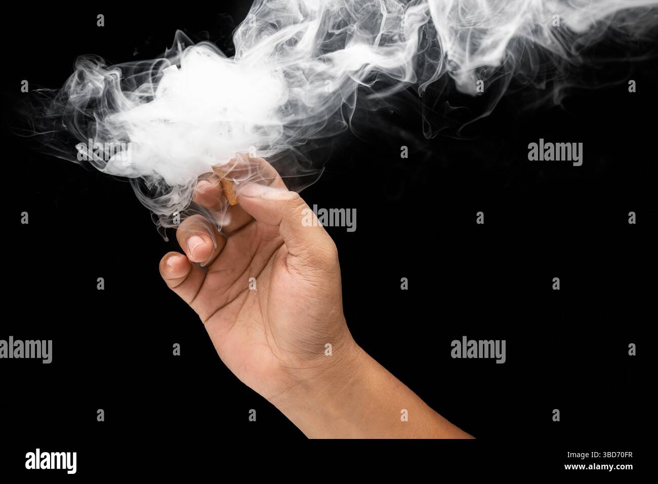 Man smoking a cigarette and releasing a cloud of smoke with a black ...