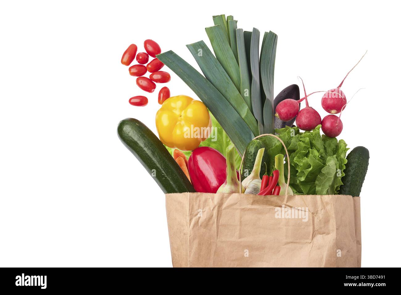 Paper bag with fresh vegetables isolated on white background Stock Photo