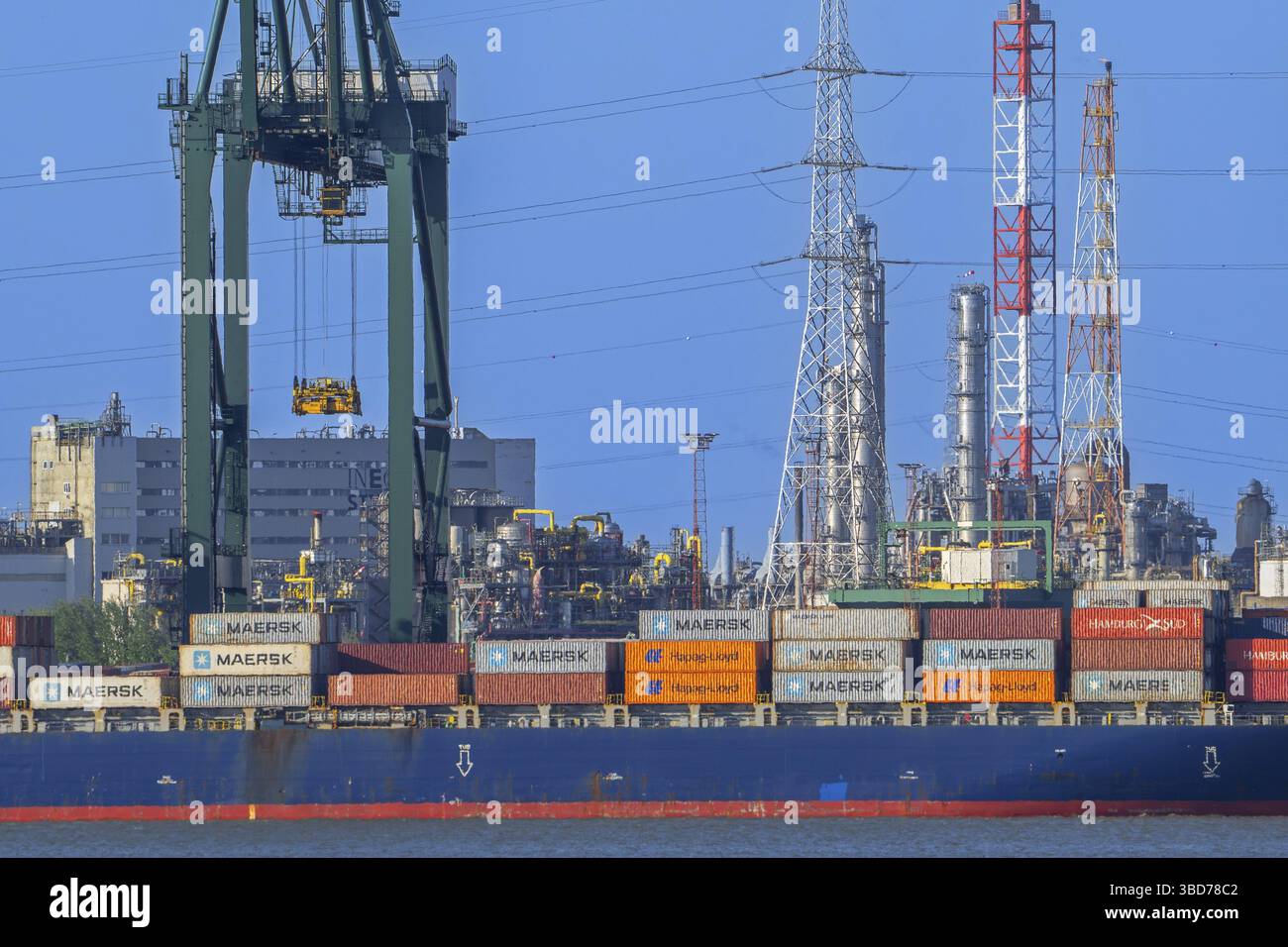 Gantry cranes and stacked containers on container ship docked at ...