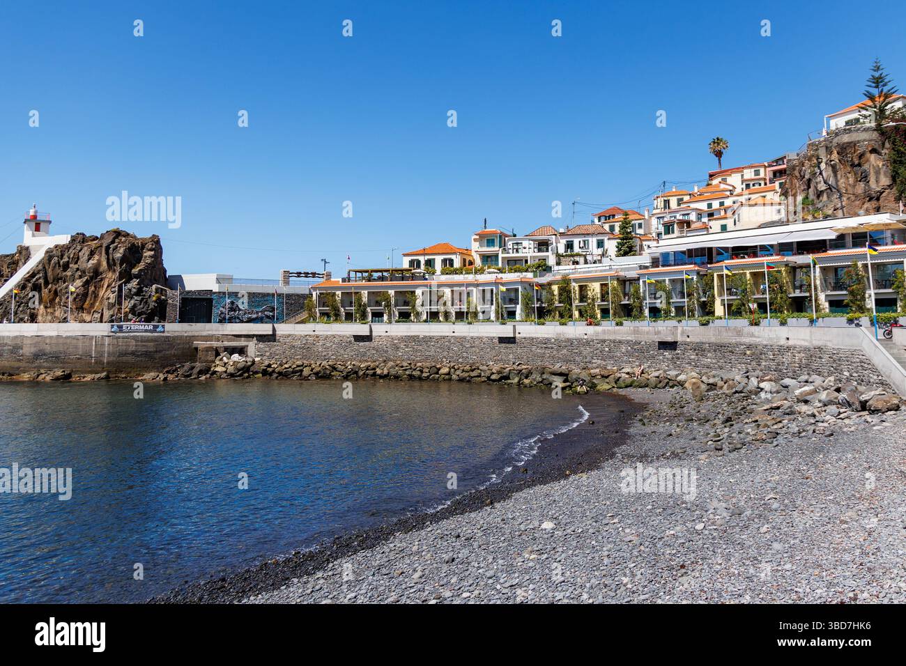 Camara de Lobos, Portugal - June 11, 2024: Bay and lighthouse in Camara de Lobos on Madeira Island Stock Photo