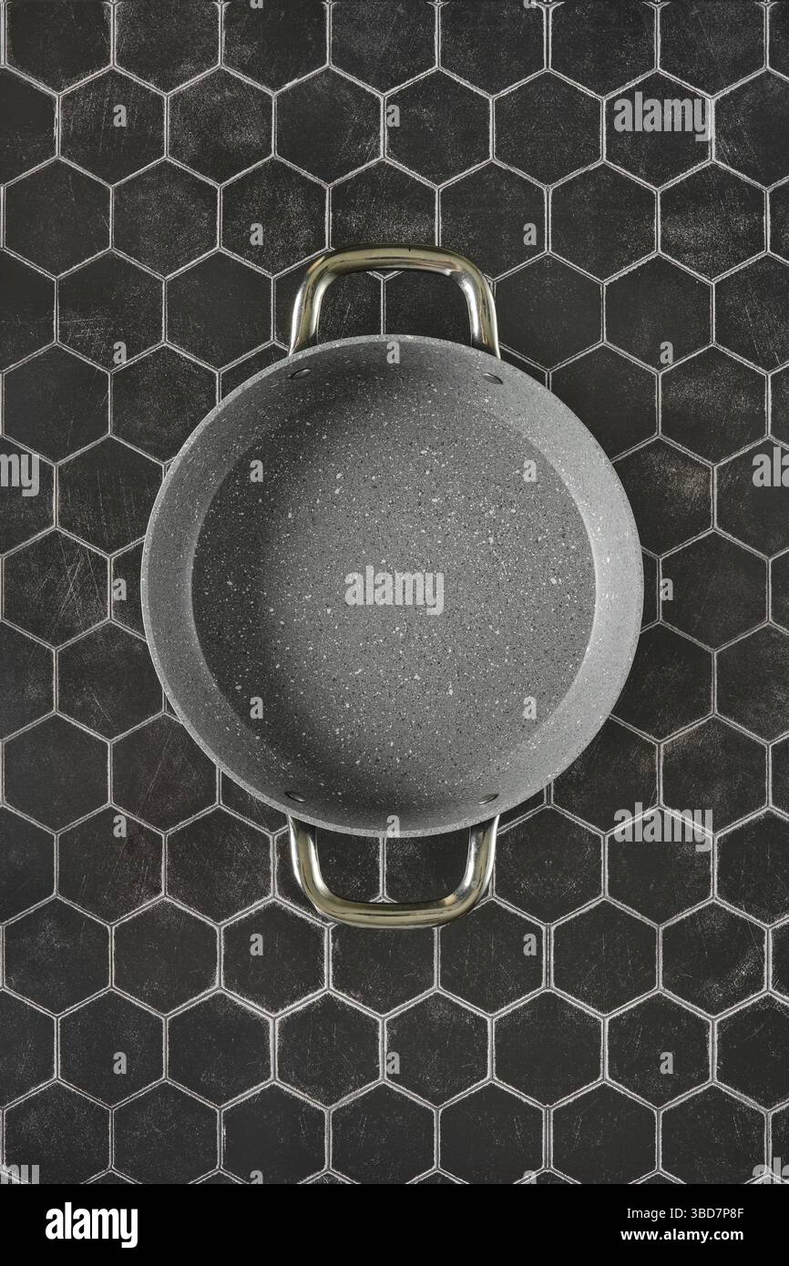 Top view of double handled non-stick frying pan on hexagon tile background Stock Photo
