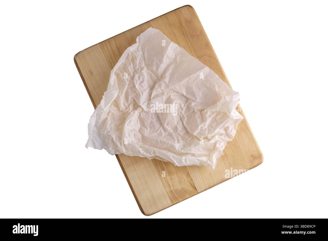 Crumpled parchment for baking isolated on white Stock Photo