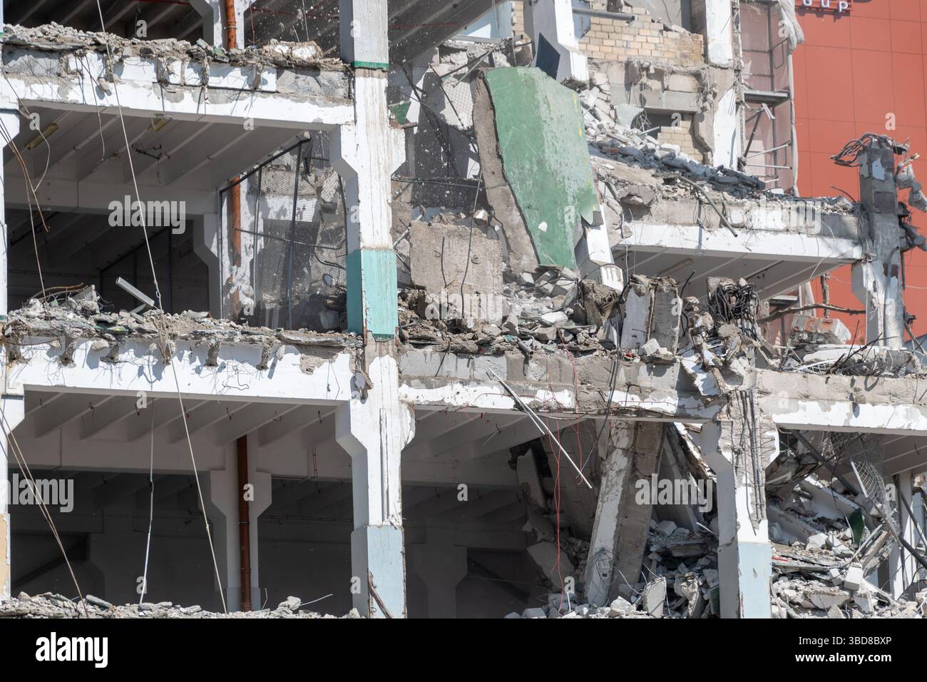 Urban building demolition with exposed structural elements and debris ...