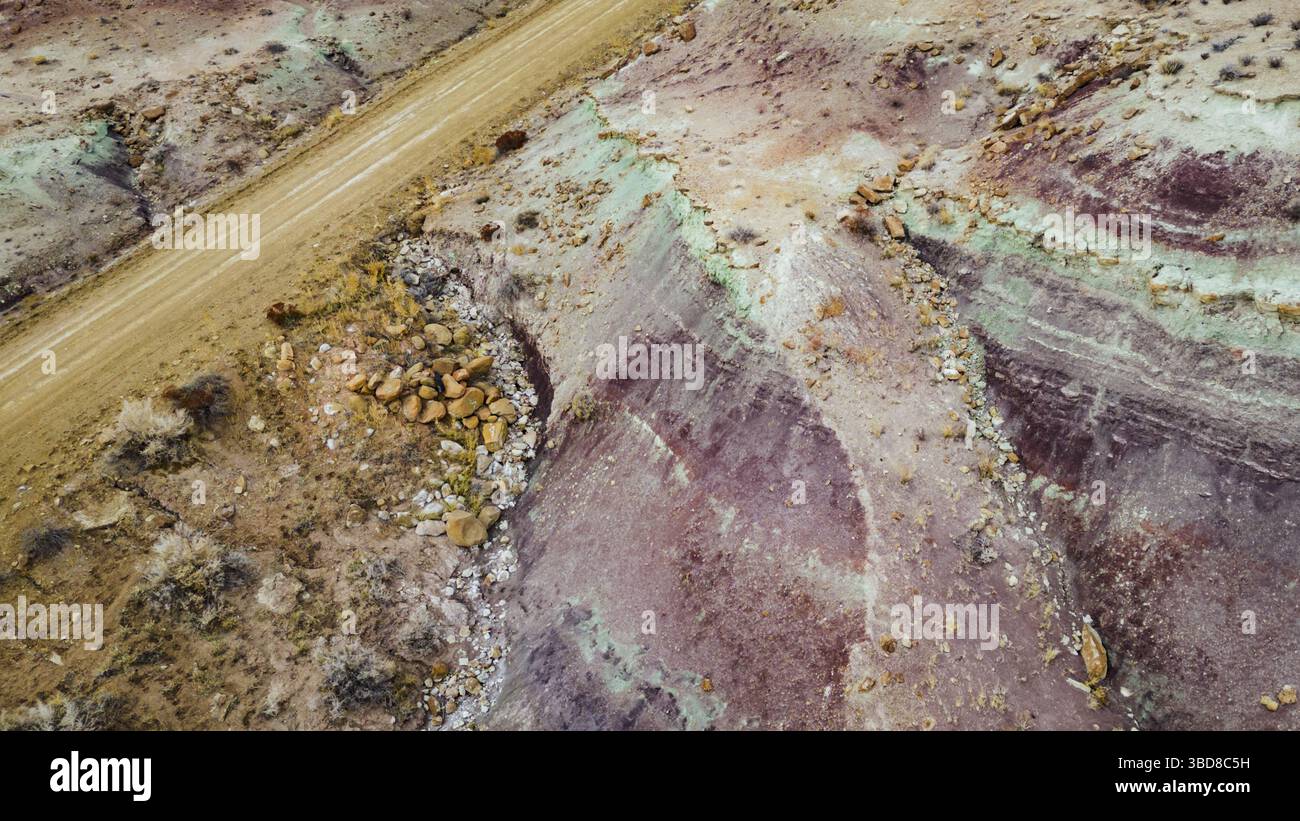 Aerial view of winding road through textured desert terrain Stock Photo ...