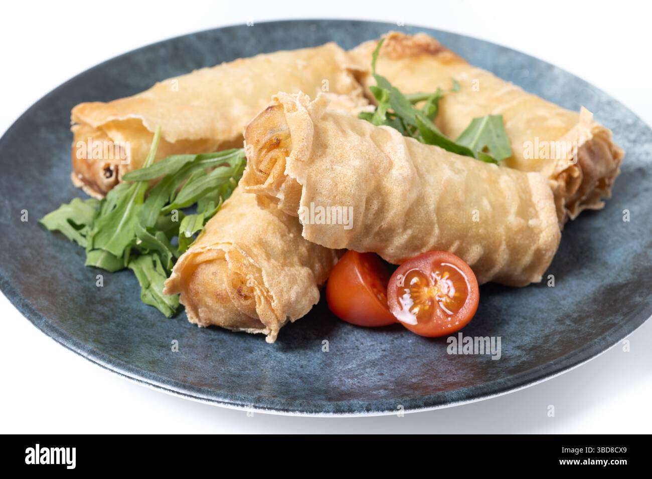 Crispy Spring Rolls on Ceramic Plate isolated on white background Stock Photo