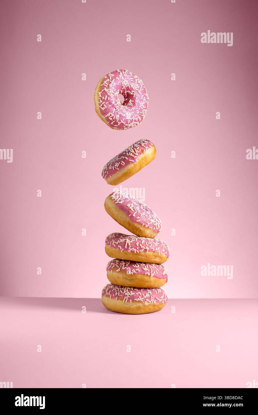Abstract pink donuts isolated on pink background levitation Stock Photo