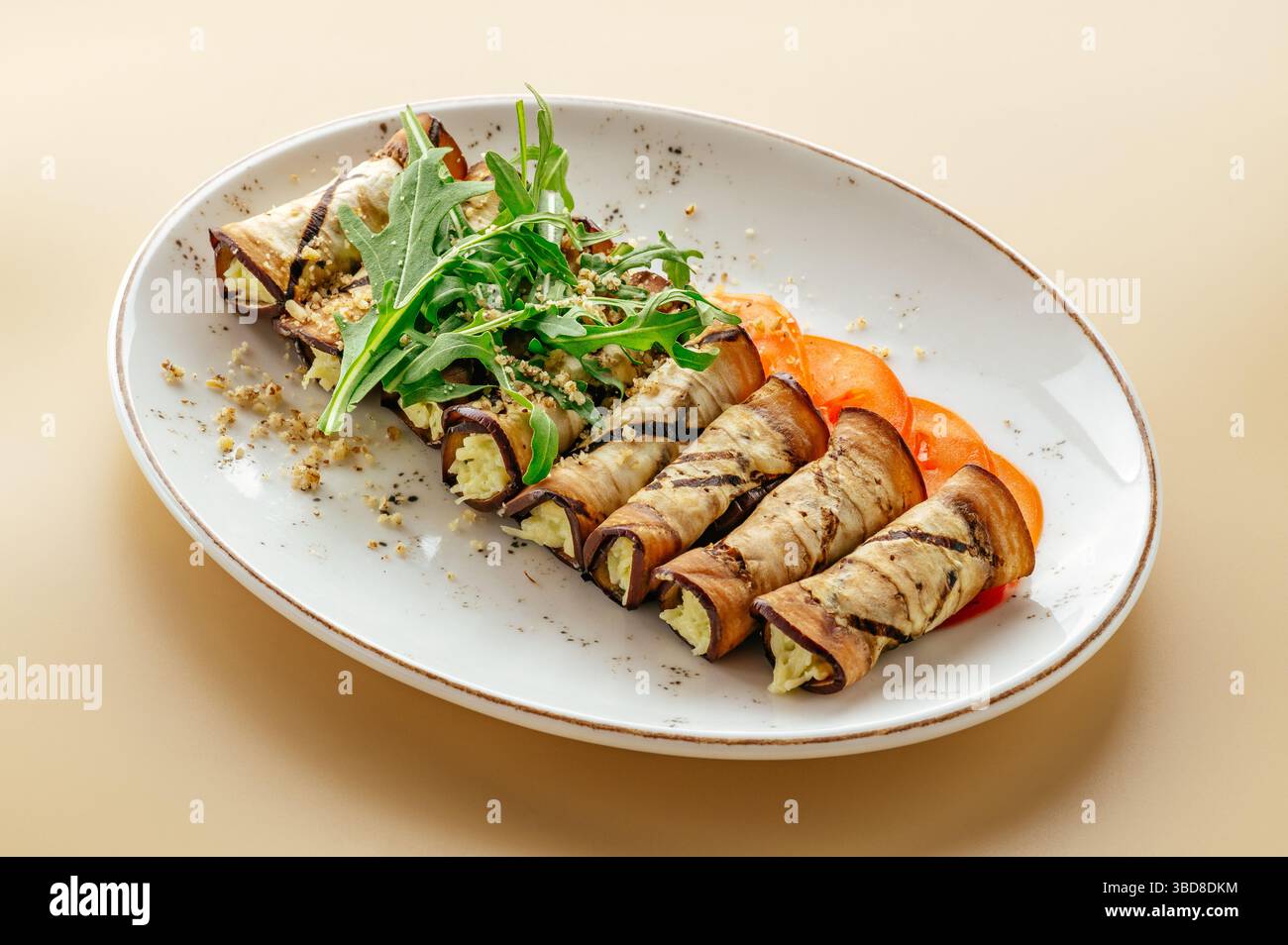 baked rolls with eggplant and herbs on a plate Stock Photo