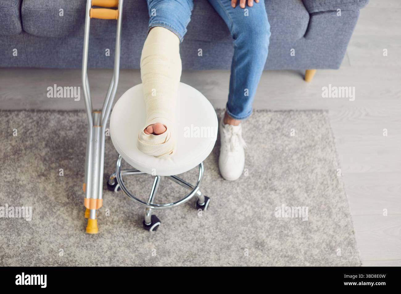 Close Up Of Man Broken Bandaged Leg During Rehabilitation Stock Photo