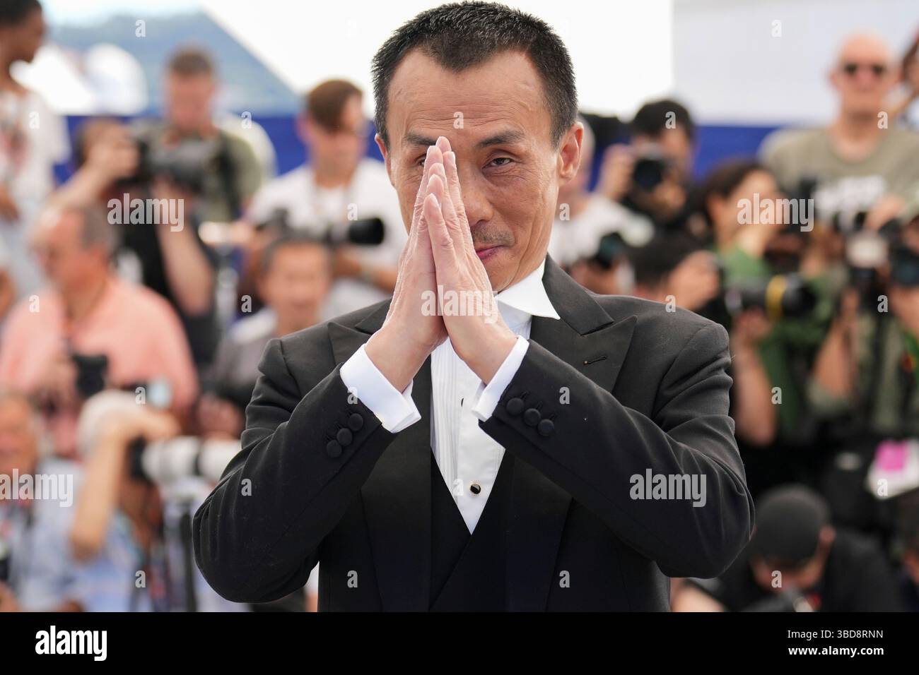 Yongzhong Chen poses for photographers at the photo call for the film ...