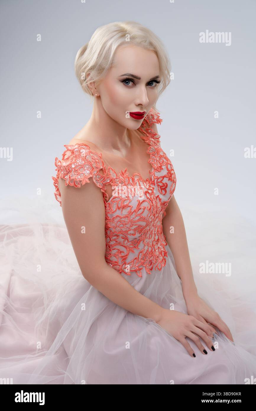 Stunning bride poses elegantly in a unique dress with a striking aesthetic Stock Photo