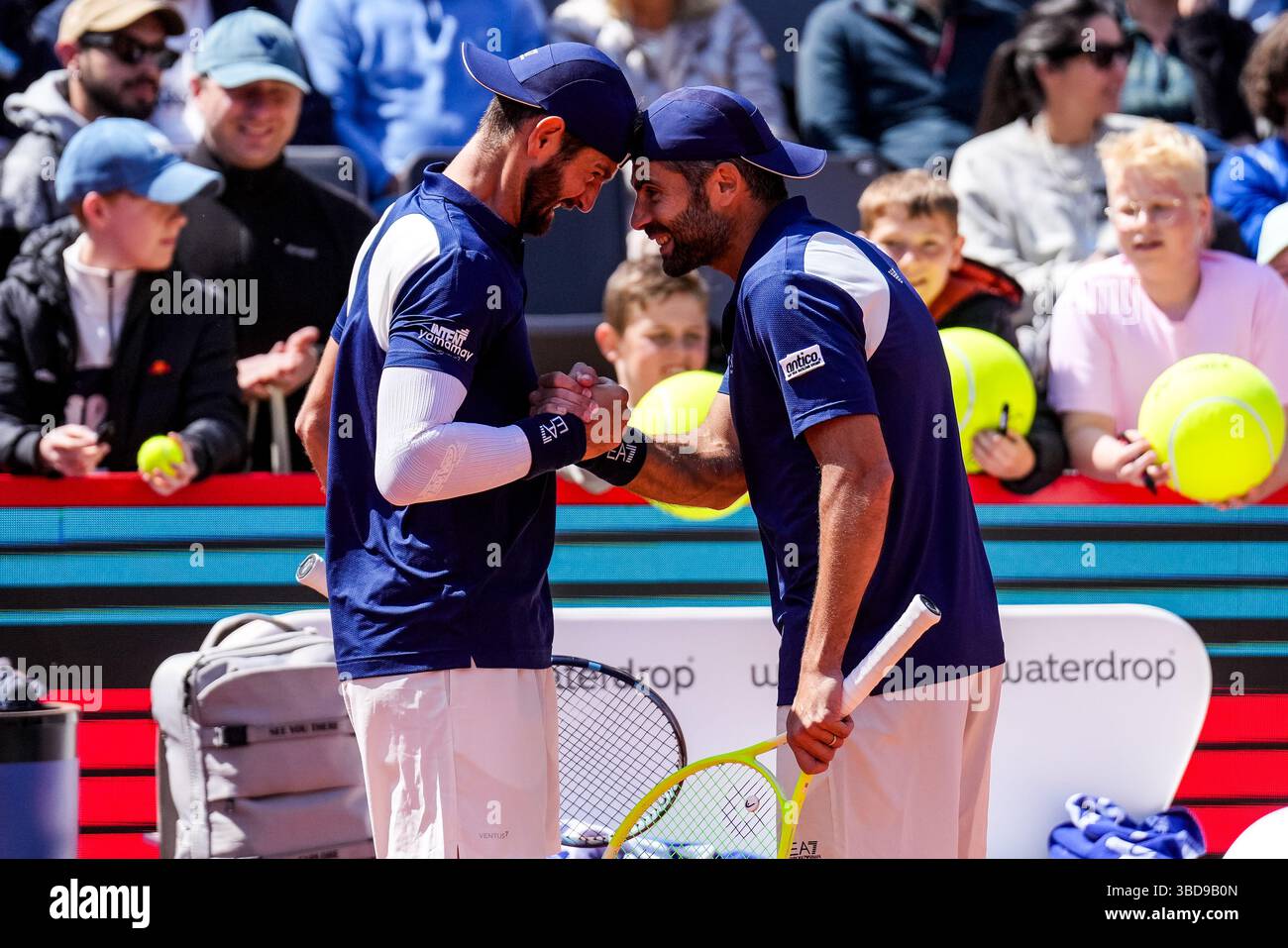 HAMBURG, GERMANY - MAY 23: Andrea Vavassori of Italy and Simone Bolelli of Italy celebrate victory after their Men's Doubles Semi Final match against Joe Salisbury of Great Britain and Neal Skupski of Great Britain during Day Seven of the Bitpanda Hamburg Open at Am Rothenbaum on May 23, 2025 in Hamburg, Germany. (Photo by Rene Nijhuis) Stock Photo