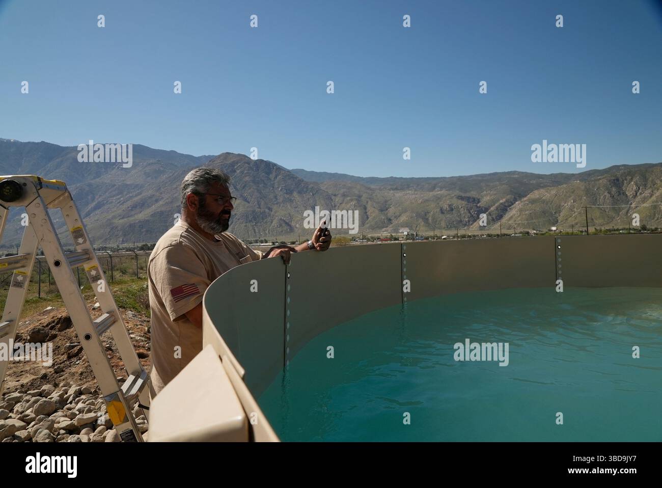 Glenn Chavez watches as water fills a newly installed Heli-Hydrant, a ...