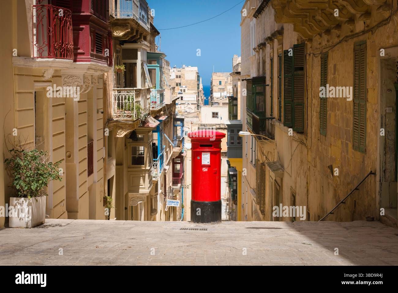 Valletta Malta, view in summer of a red post box sited in a street in the historic centre of Valletta old town, Malta Stock Photo