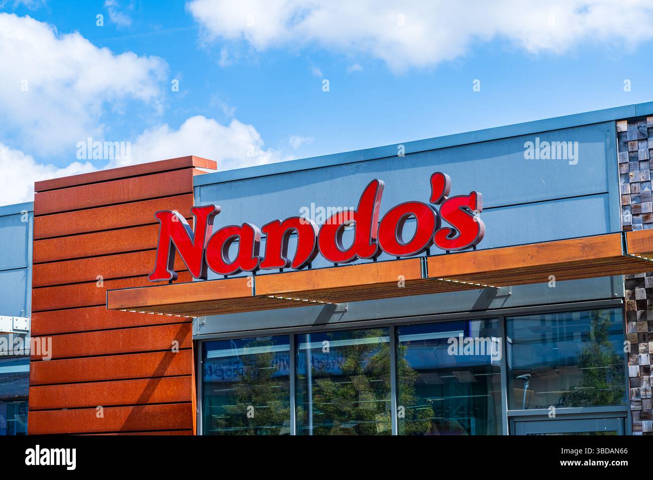 Wednesbury, UK - May 23 2025: Outside signage of a UK located, South African multinational fast food chicken restaurant, Nando's Stock Photo