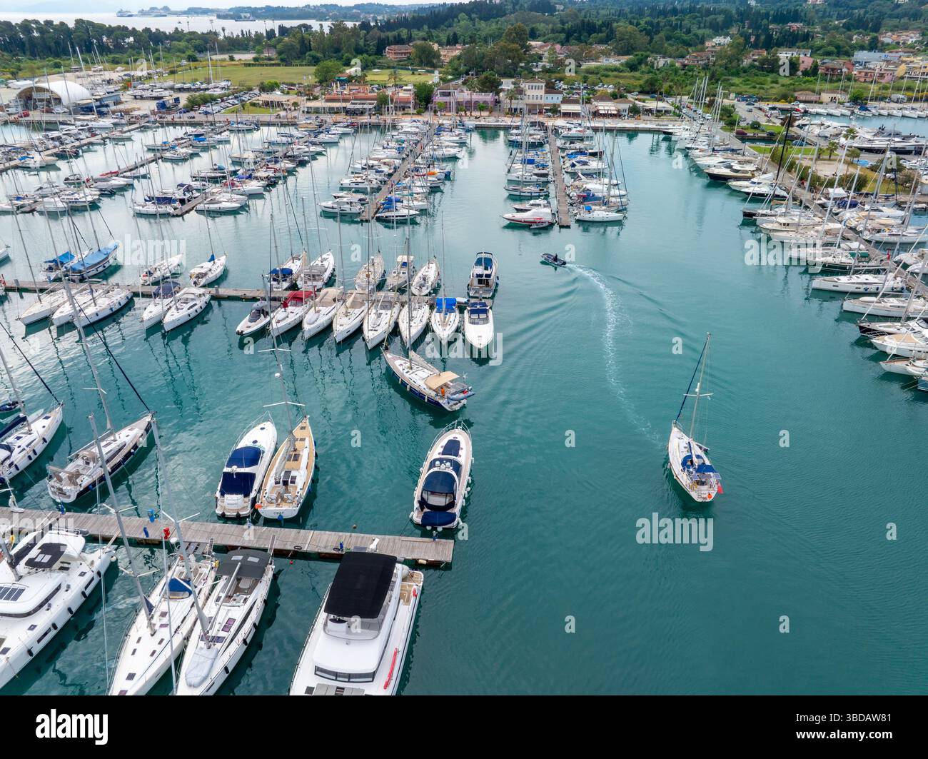 Aerial view captures sailboats and yachts docked in a marina ...