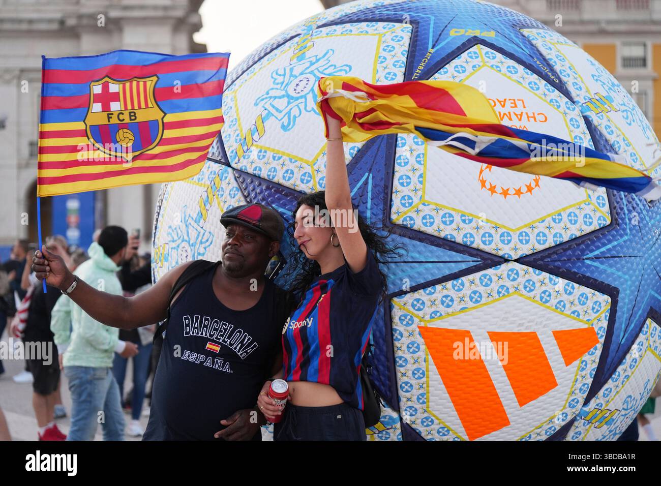 Barcelona fans pose with flags at Lisbon's riverside Comercio square ...