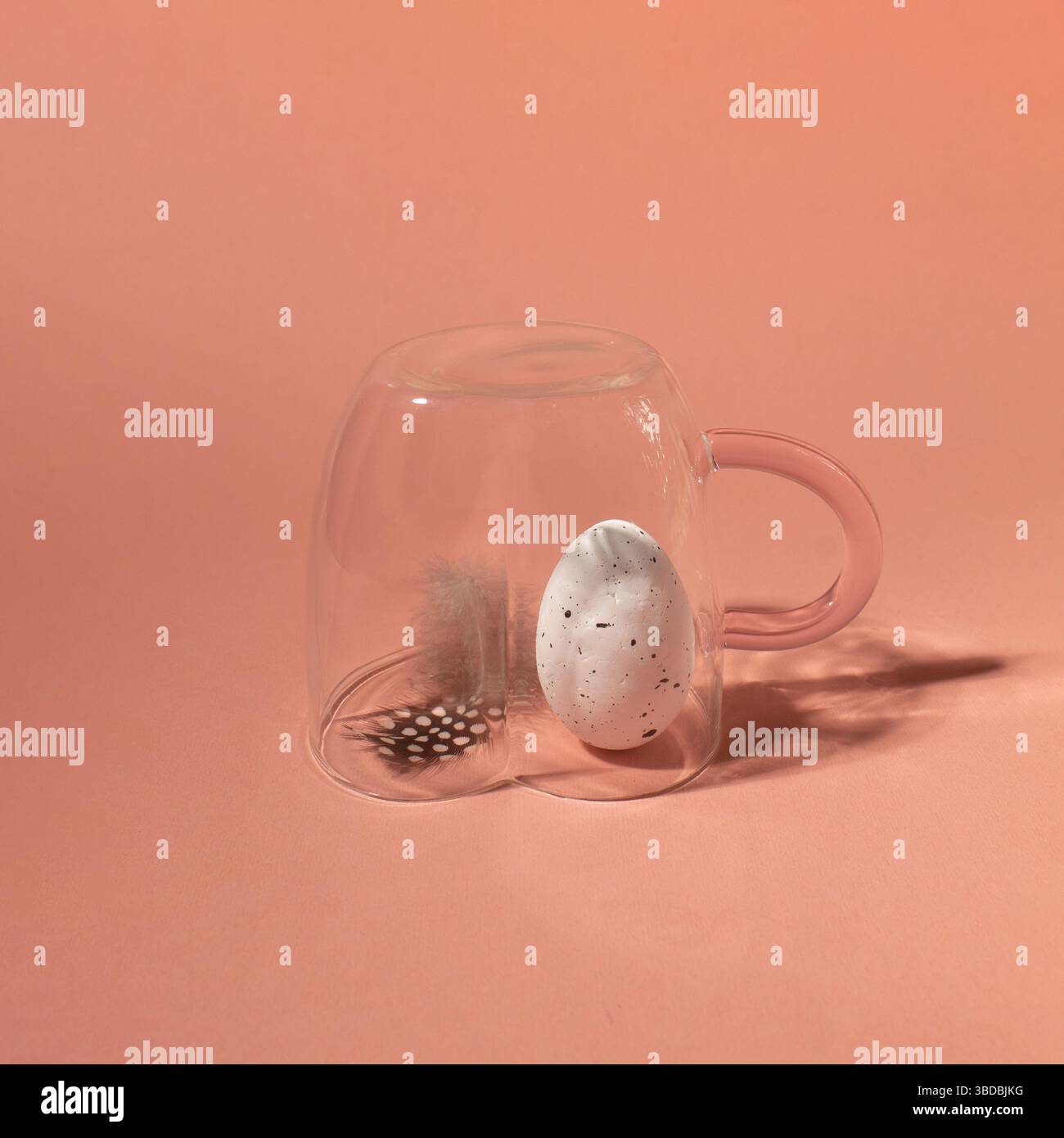 Quail egg with feather in a cup. Happy Easter concept. Close-up. Stock Photo