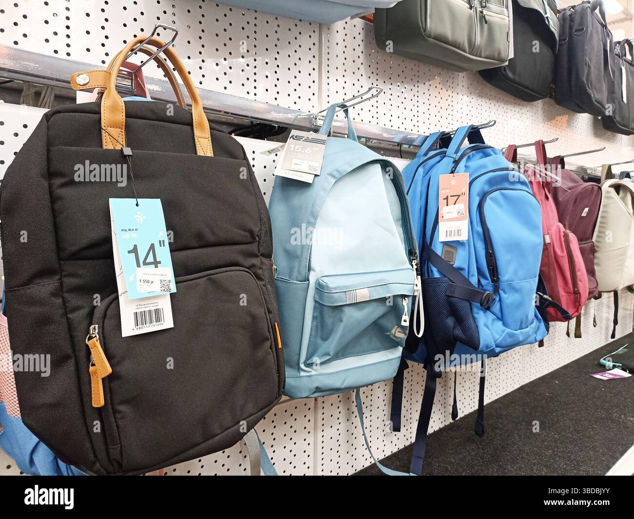 Variety of backpacks on display in store aisle with price tags Stock ...