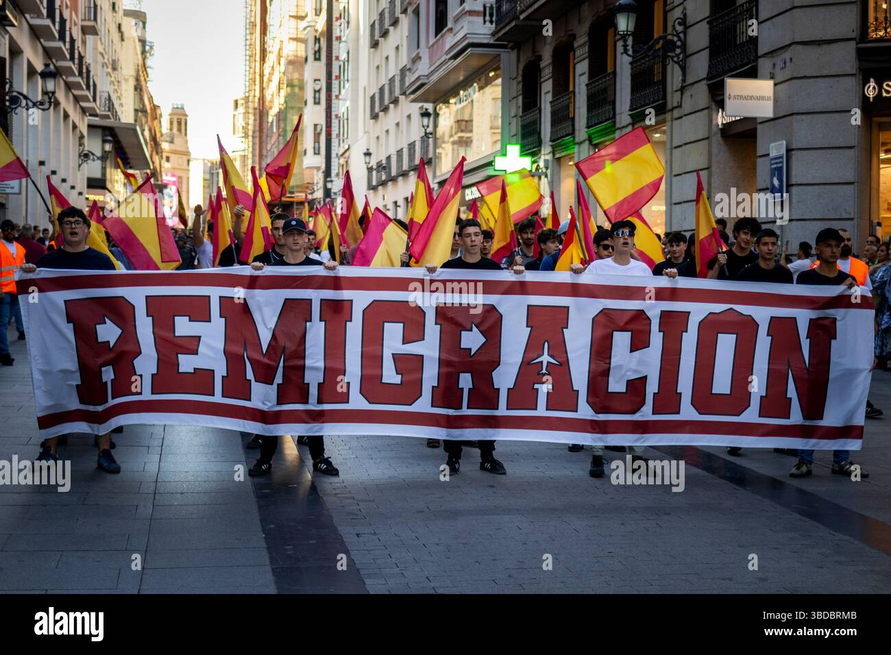 Several people hold a banner with the slogan 'Remigration' during the ...