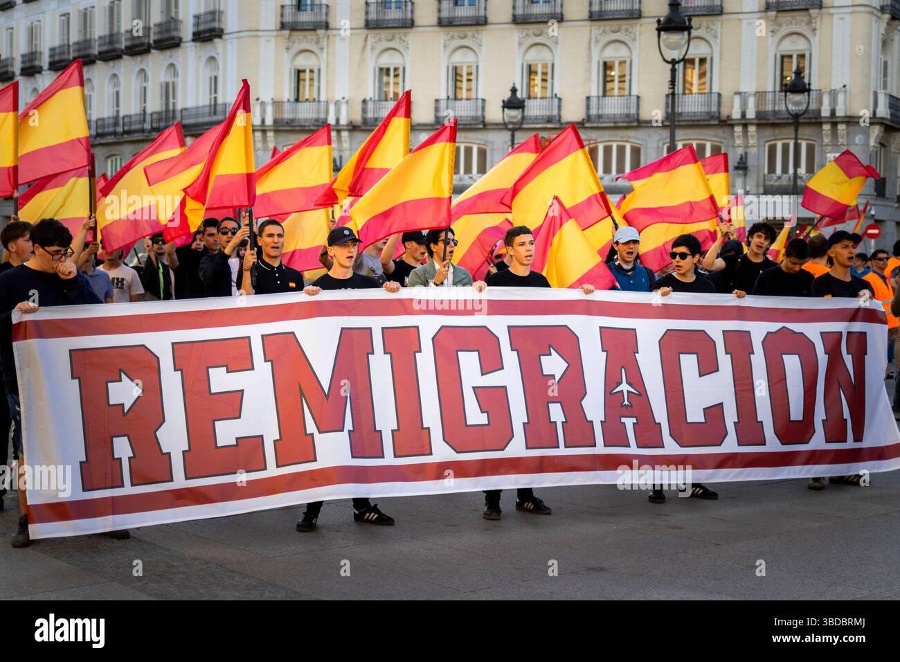 Several people hold a banner with the slogan 'Remigration' during the ...