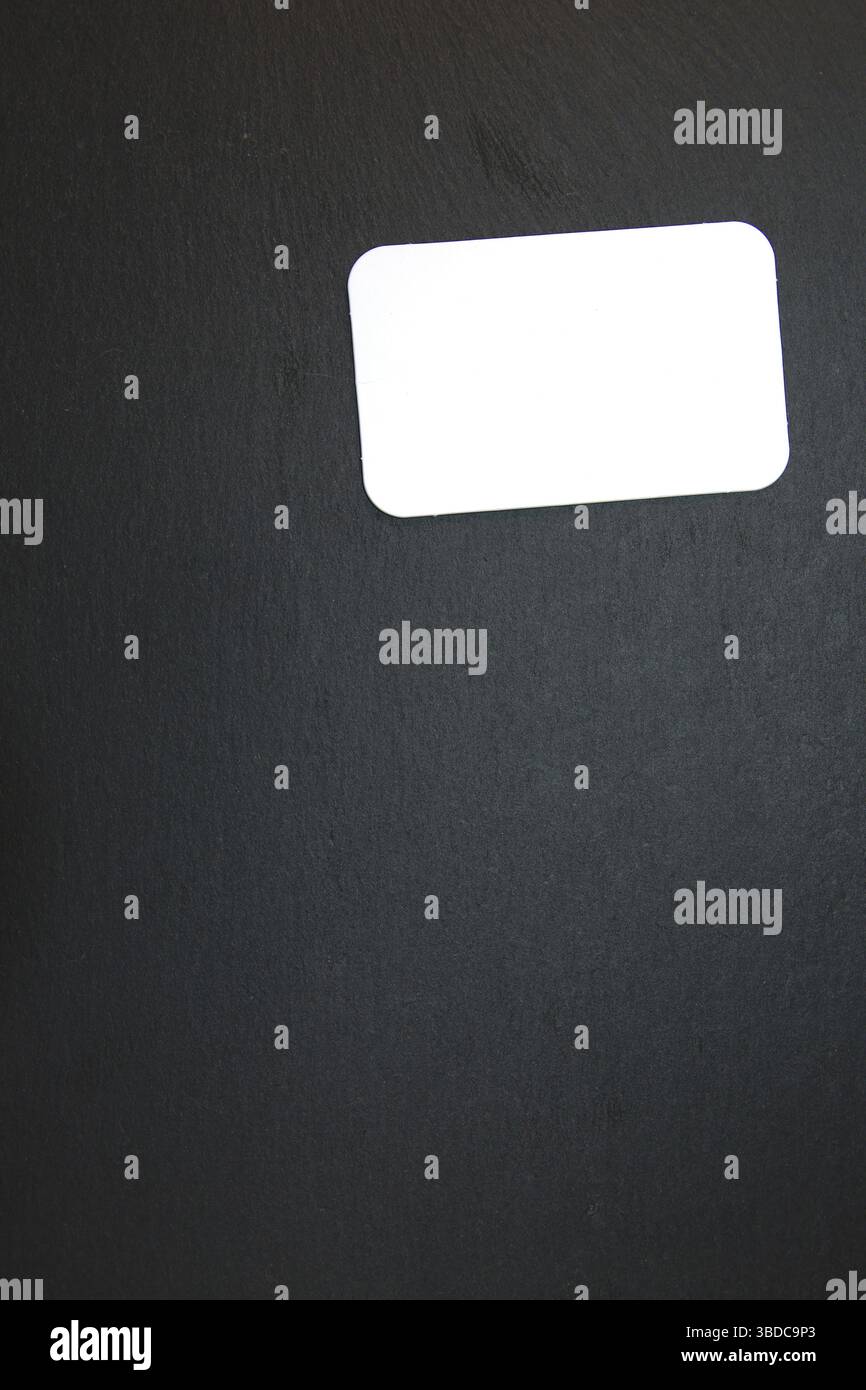 Black slate with white field for notes Blackboard (slate) with blank, writable notepad Stock Photo