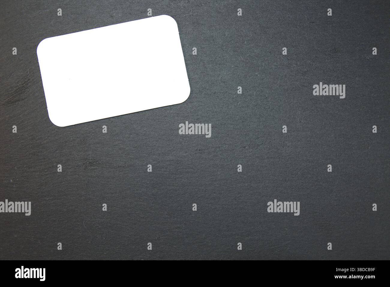 Black slate with white field for notes Blackboard (slate) with blank, writable notepad Stock Photo