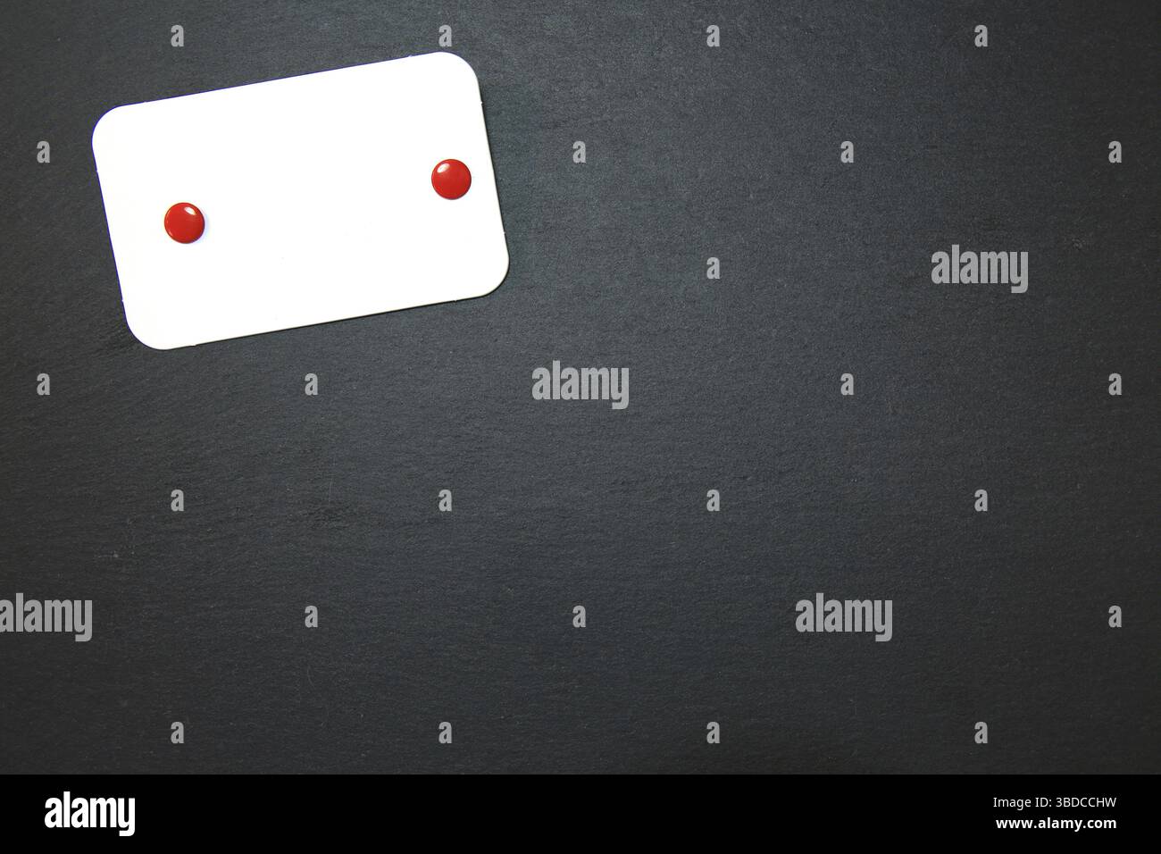 Black slate with white field for notes Blackboard (slate) with blank, writable notepad Stock Photo