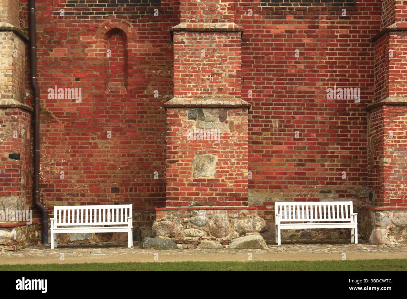 White benches in front of the church wall Stock Photo - Alamy