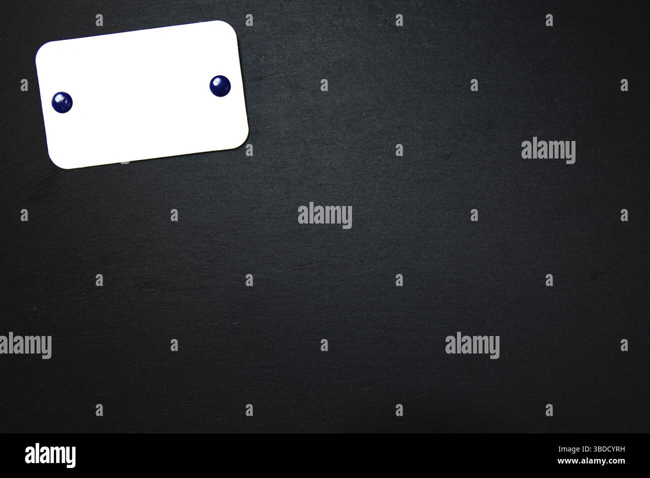 Black slate with white field for notes Blackboard (slate) with blank, writable notepad Stock Photo