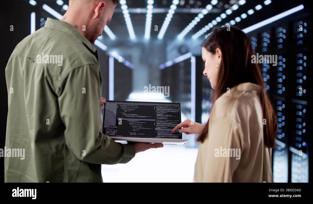 Tech-savvy Engineer Setting Up AI In Data Center Server Room. Stock Photo