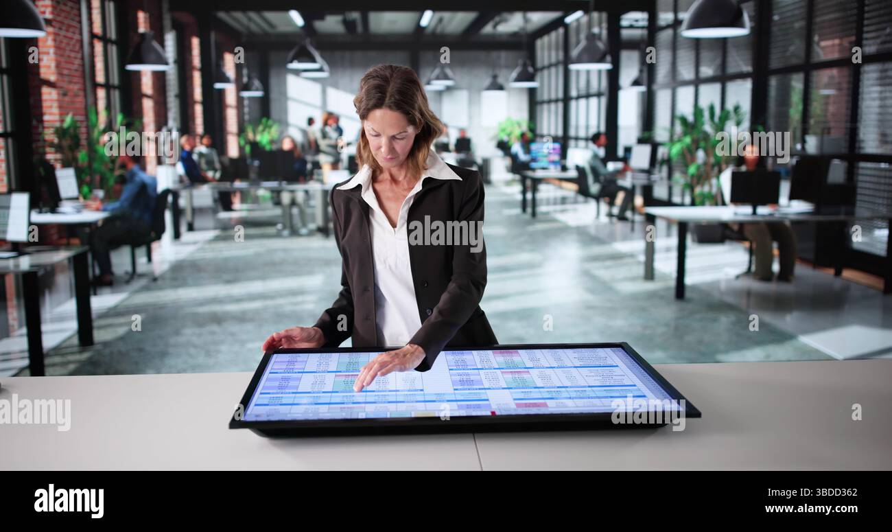 Female Accountant Analyzing Medical Data On Electronic Spreadsheet In Office Stock Photo