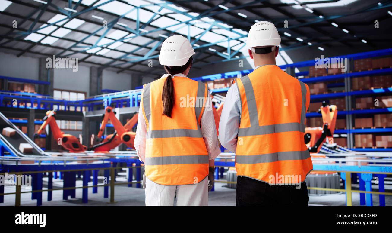 Busy Workers At Warehouse Discussing Packaging And Logistics Operations Efficiency. Stock Photo
