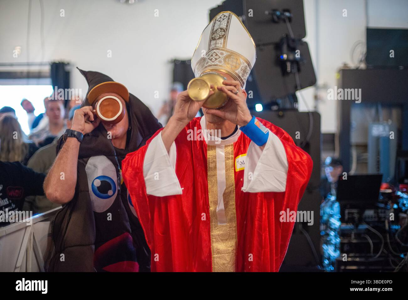 Participants compete in the “Pope and Poop Relay” contest during the ...