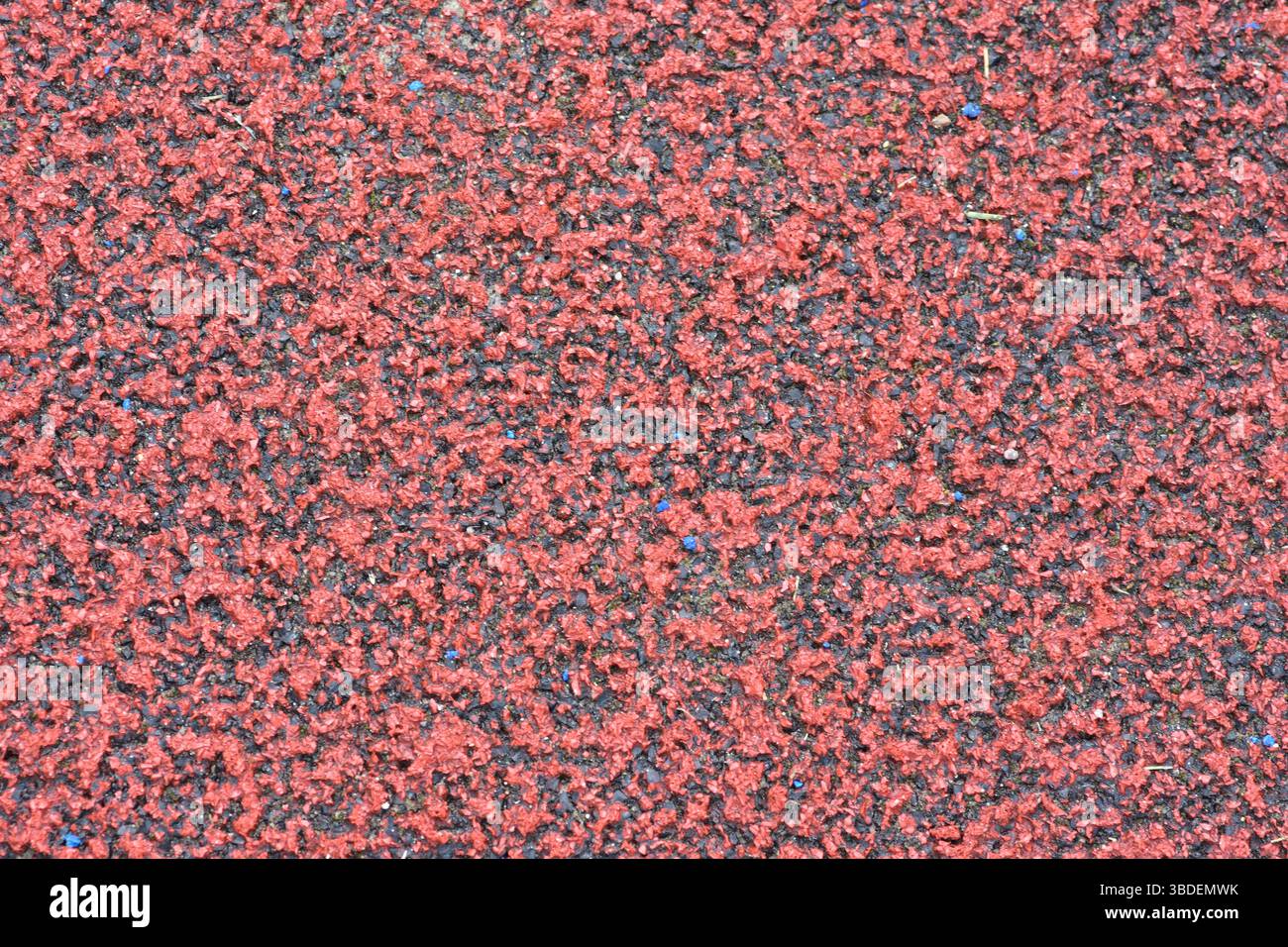 Red Texture Coating Red sports field rubber coating close up macro view. Playground paving ...