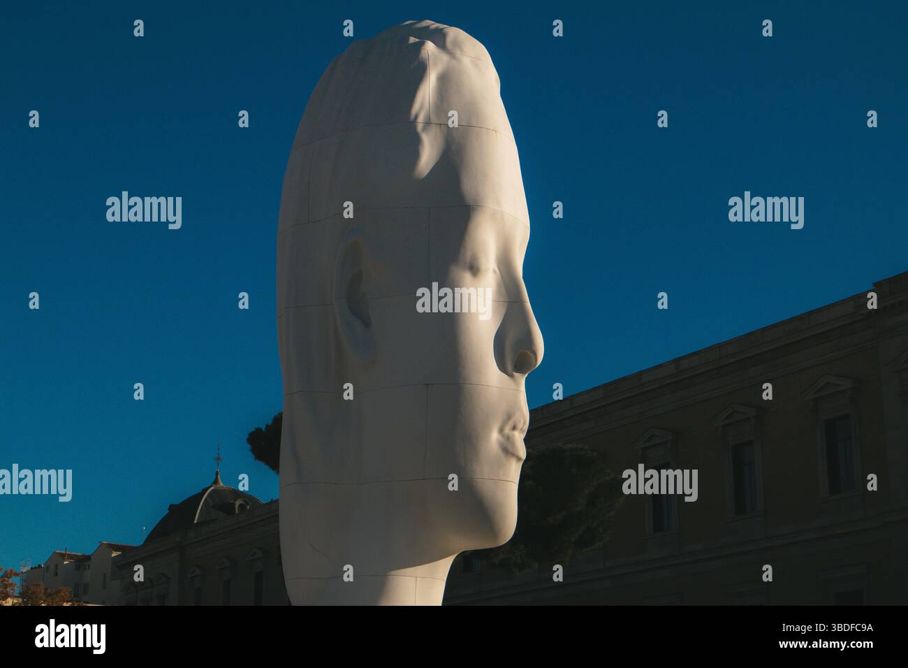 Madrid, Spain 1 July 2023 A monumental white head sculpture against blue sky. Modern sculpture titled Julia by Jaume Plensa Sune located at the Plaza Stock Photo