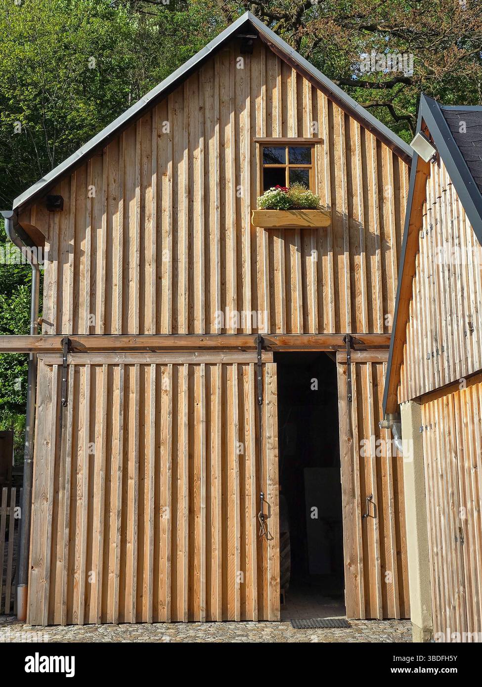 old wooden barn or garage with wooden board facade Stock Photo