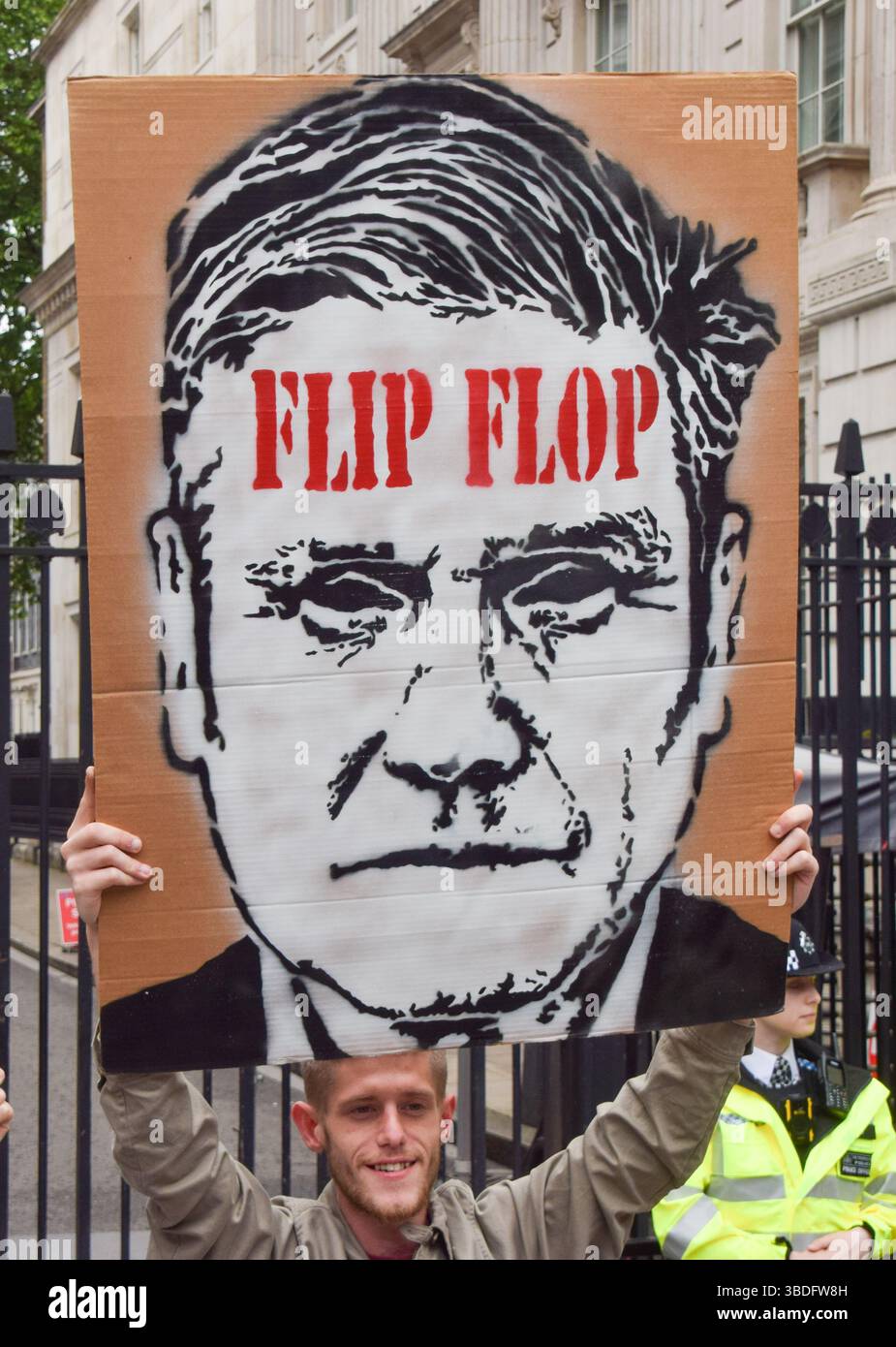 London, UK. 24th May 2025. A protester holds a sign referring to Keir ...