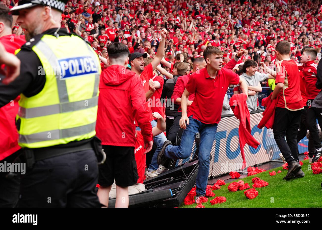 Aberdeen fans invade the pitch after thier team scored a late equaliser ...