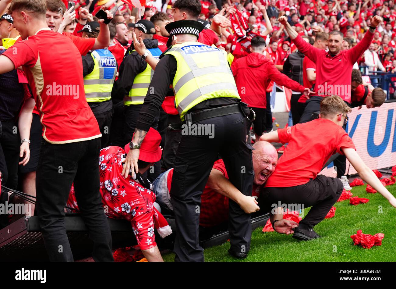 Aberdeen fans invade the pitch after thier team scored a late equaliser ...