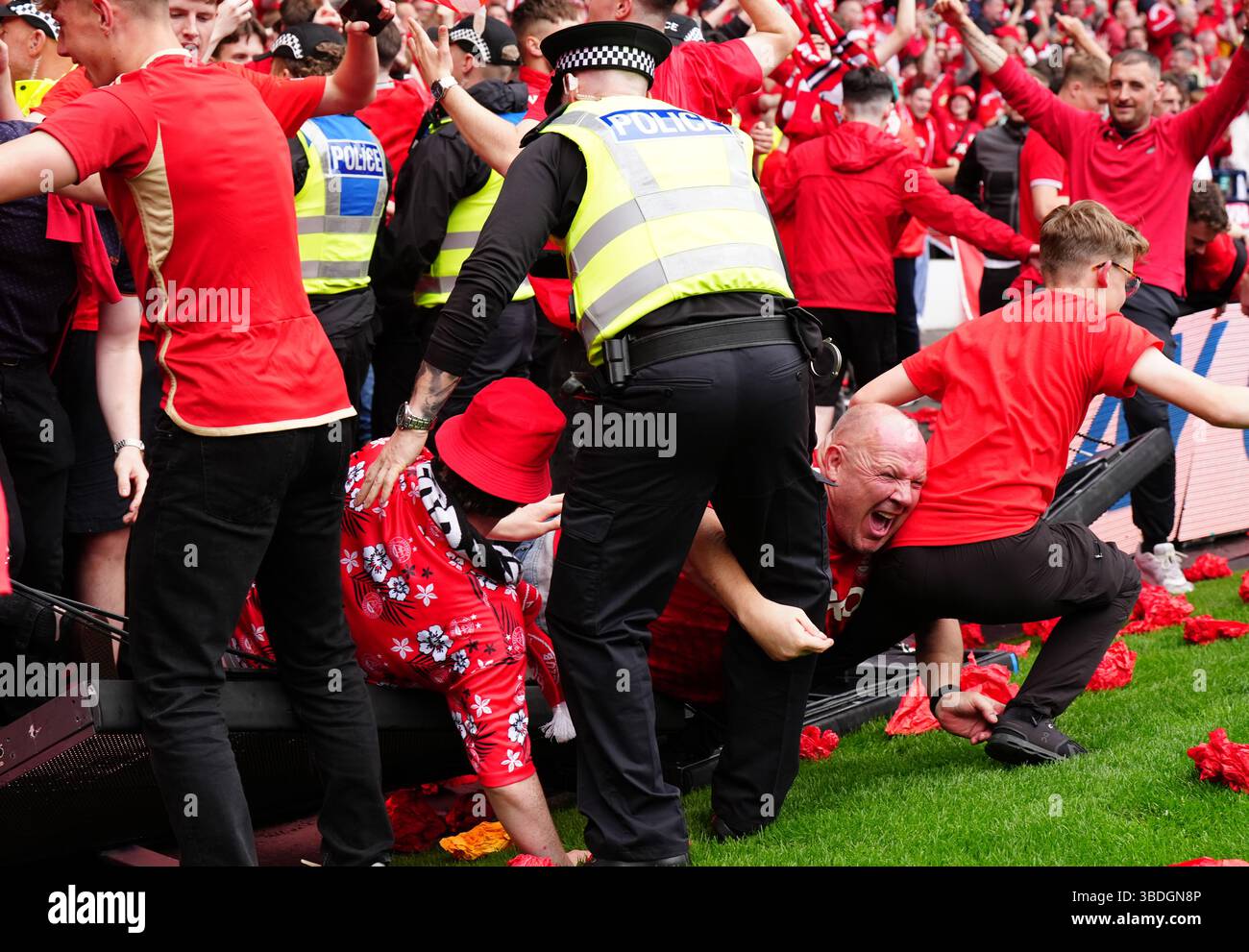 Aberdeen fans invade the pitch after thier team scored a late equaliser ...