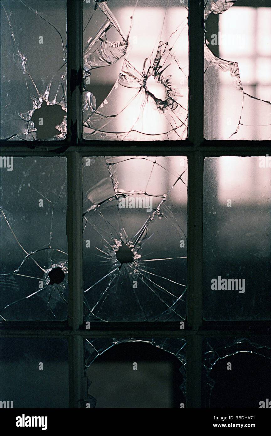 Broken window panes in abandoned building Stock Photo