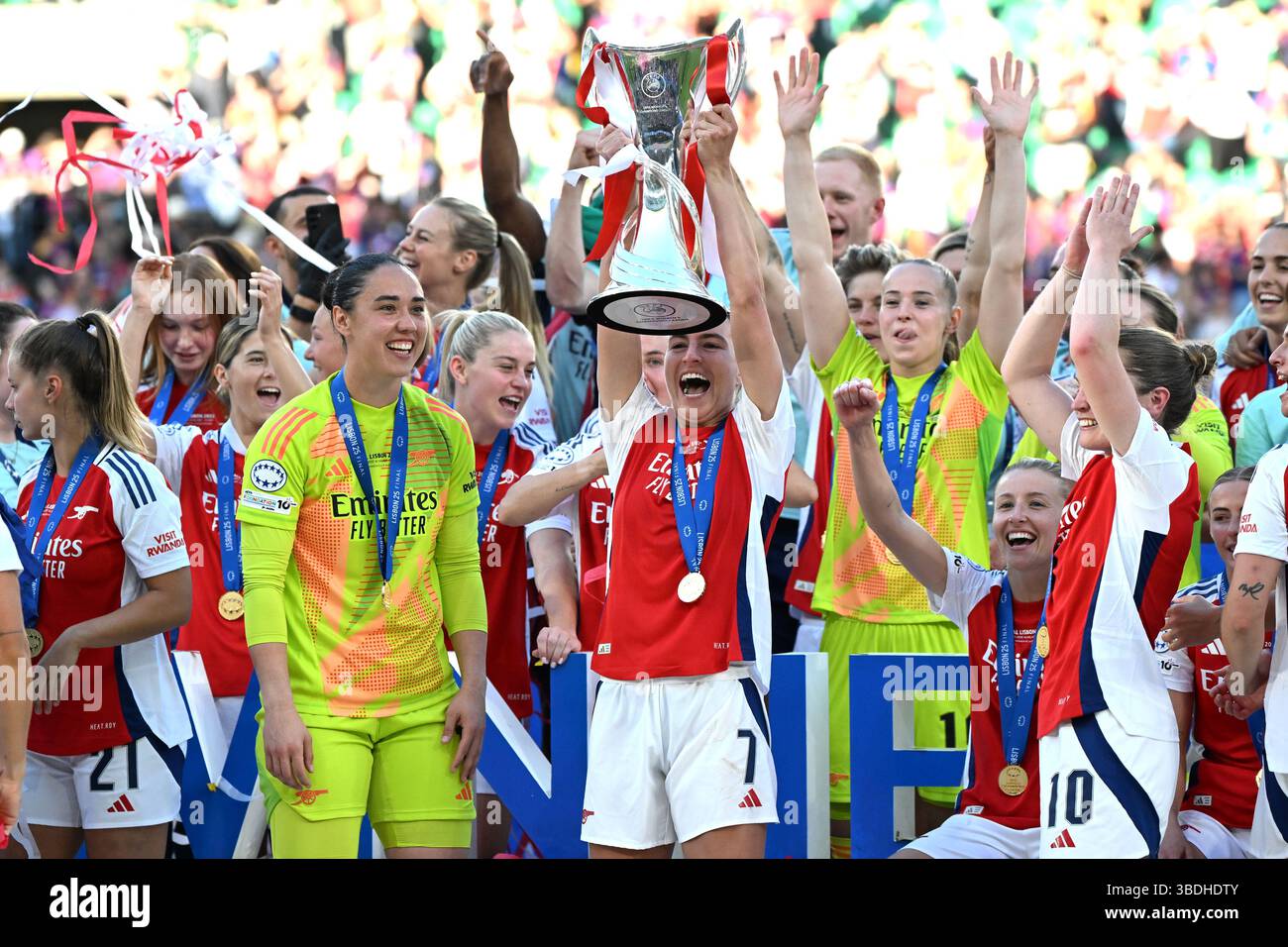 Arsenal's Steph Catley (centre) lifts the trophy with team-mates ...