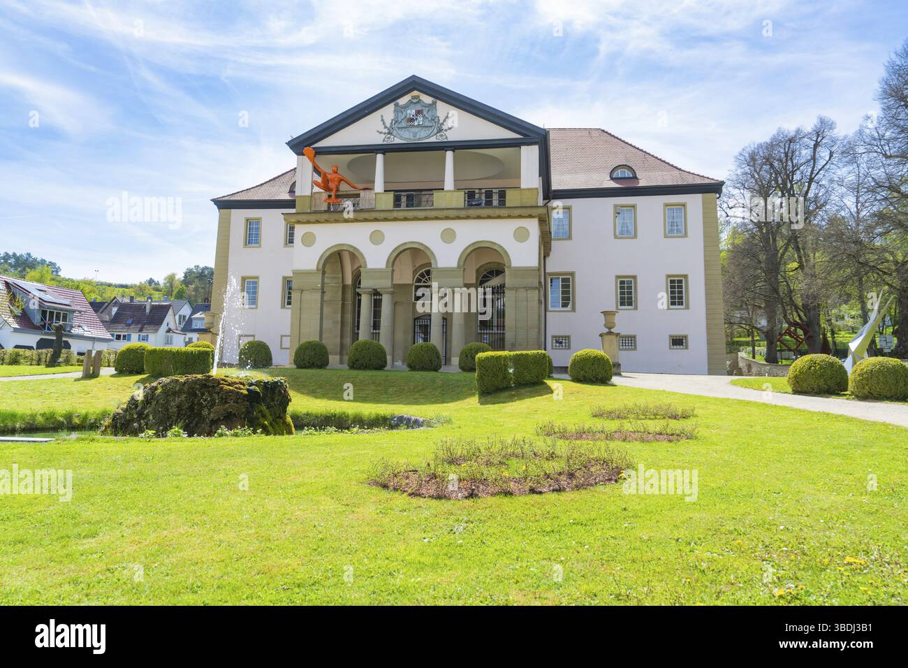 Historic building with classical elements, surrounded by a well-tended garden and under a clear blue sky, Schloss Daetzingen, Grafenau, Germany, Europ Stock Photo