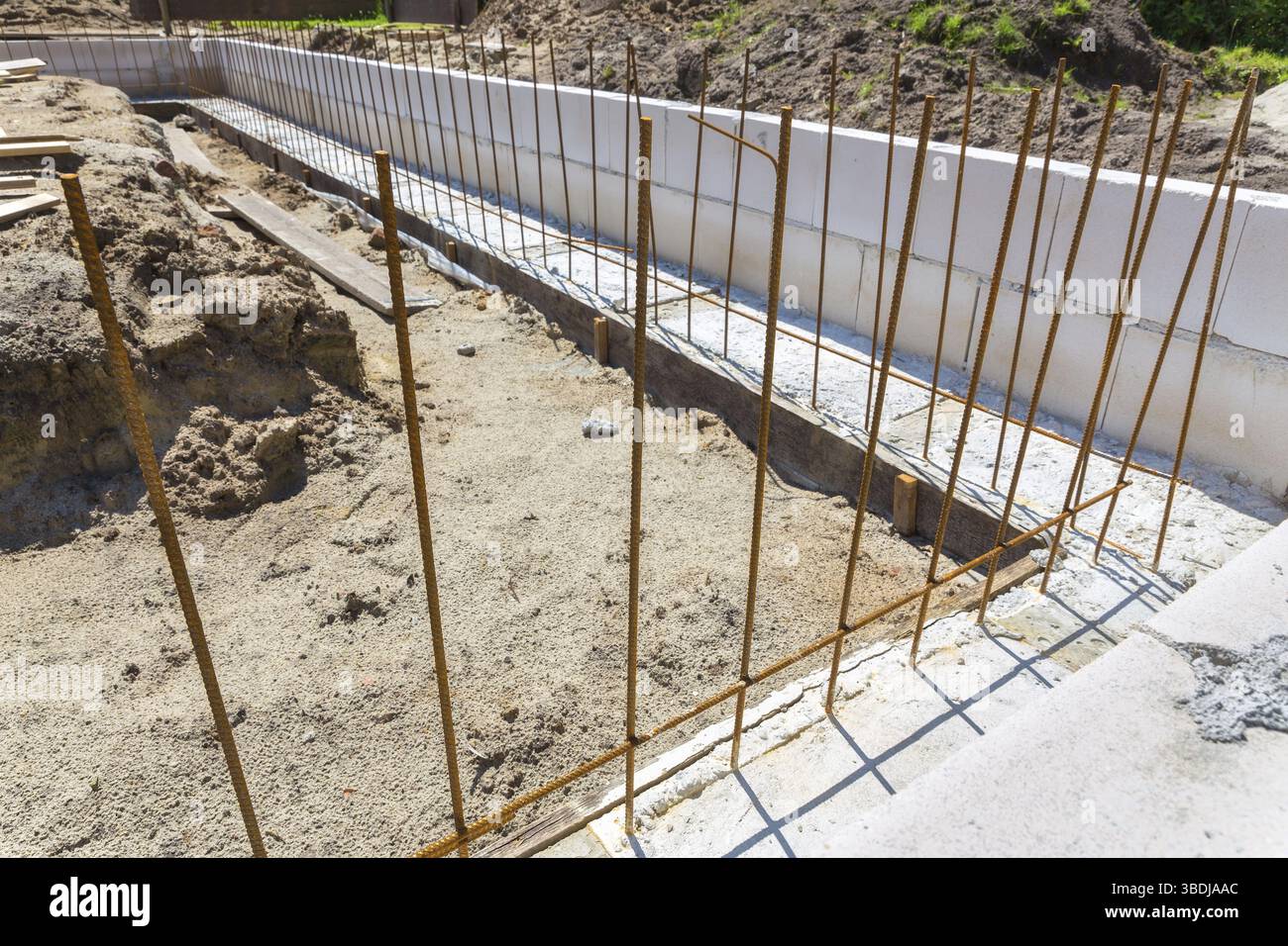 Construction site with metal rods in concrete foundation Stock Photo ...